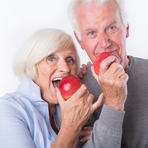 two patients with dentures eating