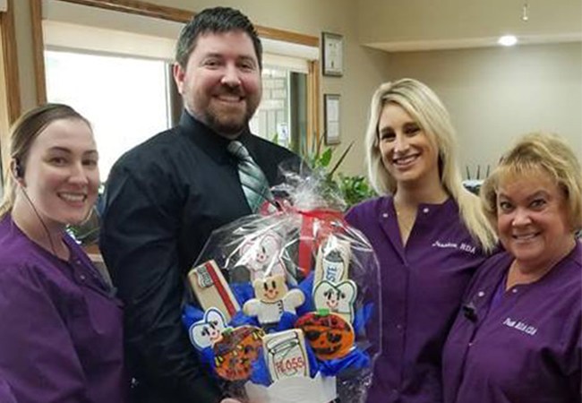 Team member handing out award to patient