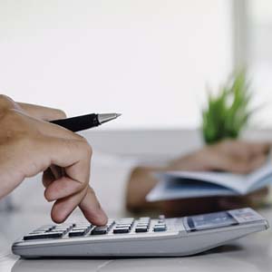 Man calculating cost of dental emergency in Bettendorf