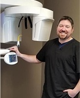 Dentist posing with 3D CT scanner