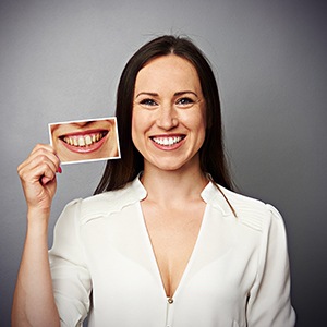 Woman holds before and after at-home teeth whitening photos