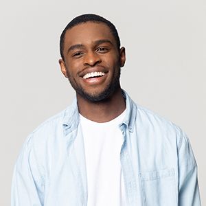 Man smiles after getting at-home teeth whitening