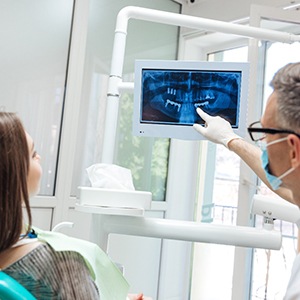 dentist showing a patient their dental X-rays