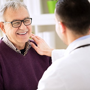 dentist putting his hand on a patient’s shoulder