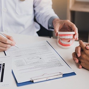 Dental insurance forms on clipboard