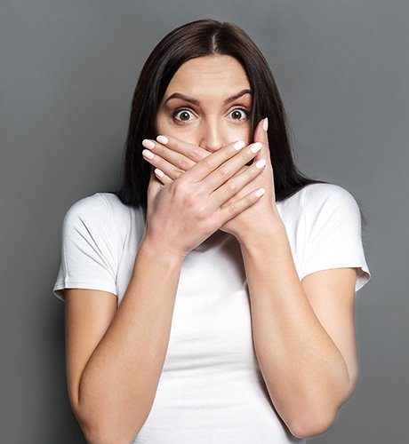 Woman covering her mouth