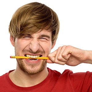 Man biting a pencil