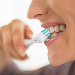 Closeup of woman brushing her teeth