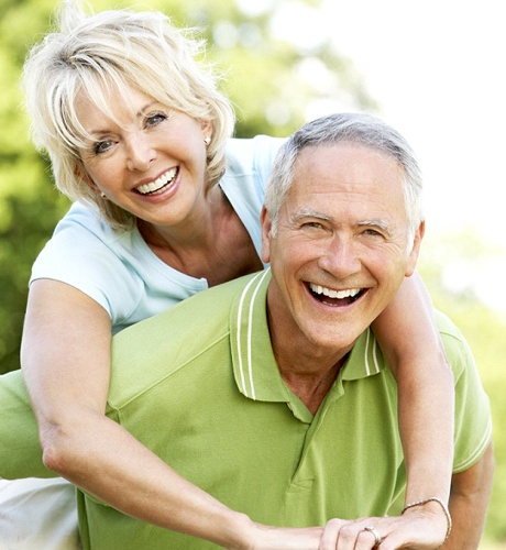 elderly couple holding each other 