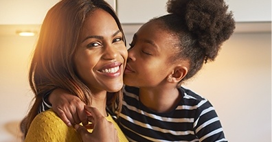 Daughter kissing mother on cheek