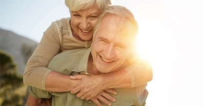 Smiling older man and woman outdoors