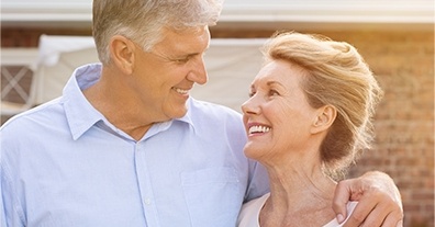 Smiling older man and woman outdoors