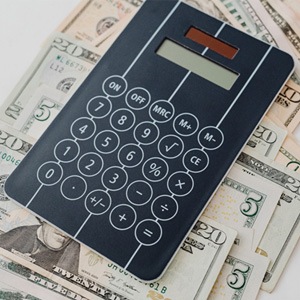 Calculator and cash on white background