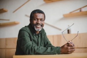 older man smiling with dental implants