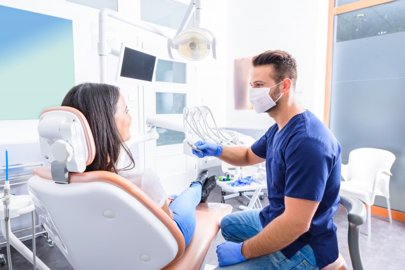 Dentist talking to patient during routine visit