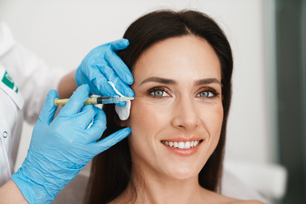 Closeup of woman smiling while getting BOTOX