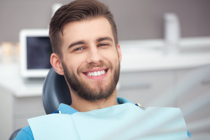 patient smiling after receiving cosmetic dental work