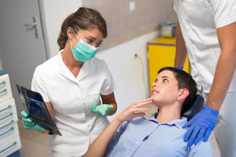 Patient asking dental team about dental implants surgery